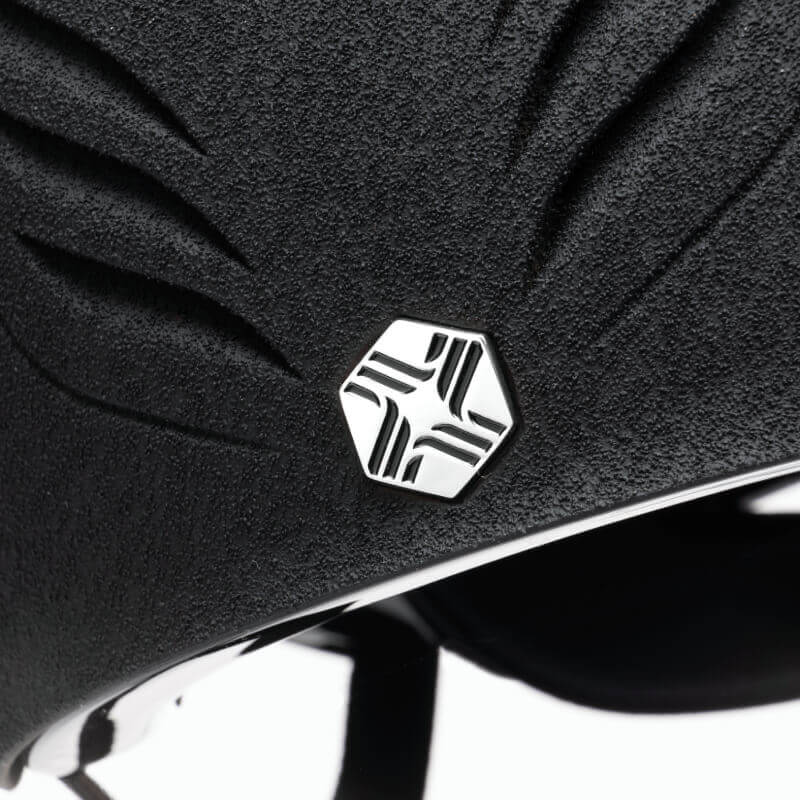 Close-up of EQx by Charles Owen Phoenix Jockey Skull Black/Silver with hexagonal metallic logo.