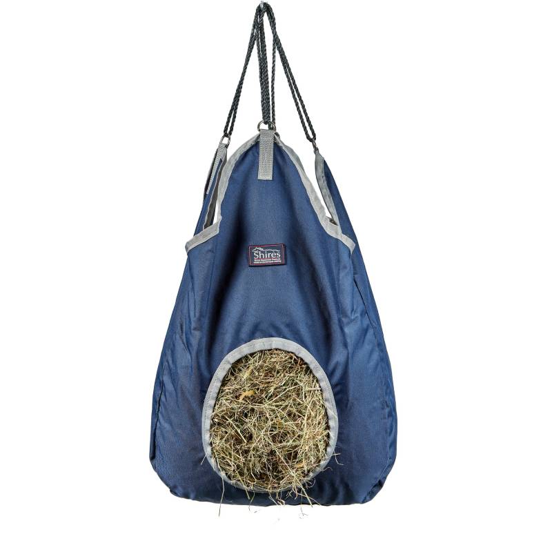 Shires Hay Bag Navy by Shires, round opening, filled with hay on white background.