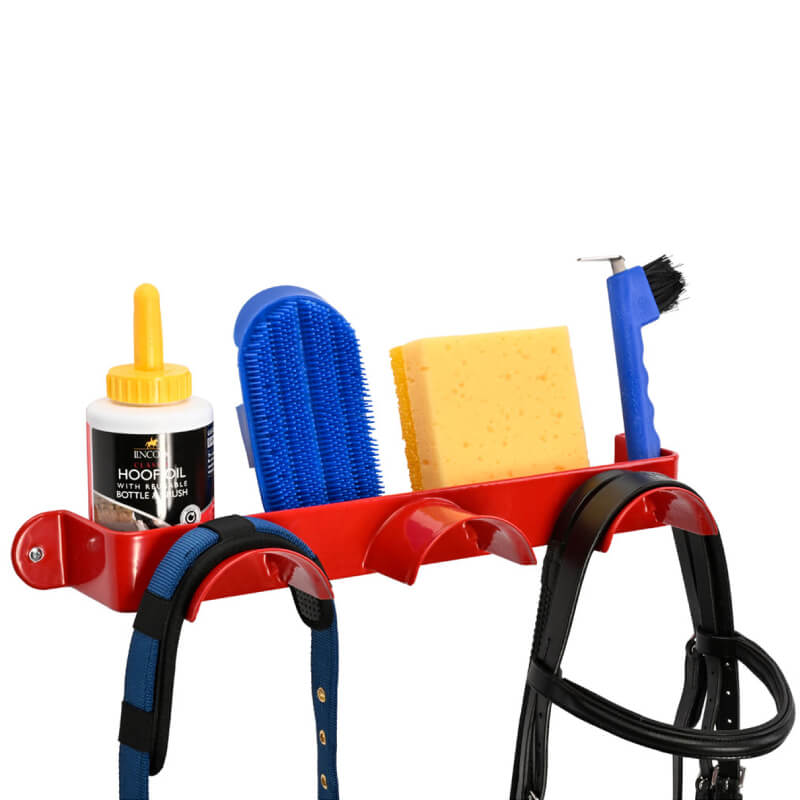 Stubbs Bridle Shelfie Red by Stubbs holds grooming supplies, a sponge, and horse tack.