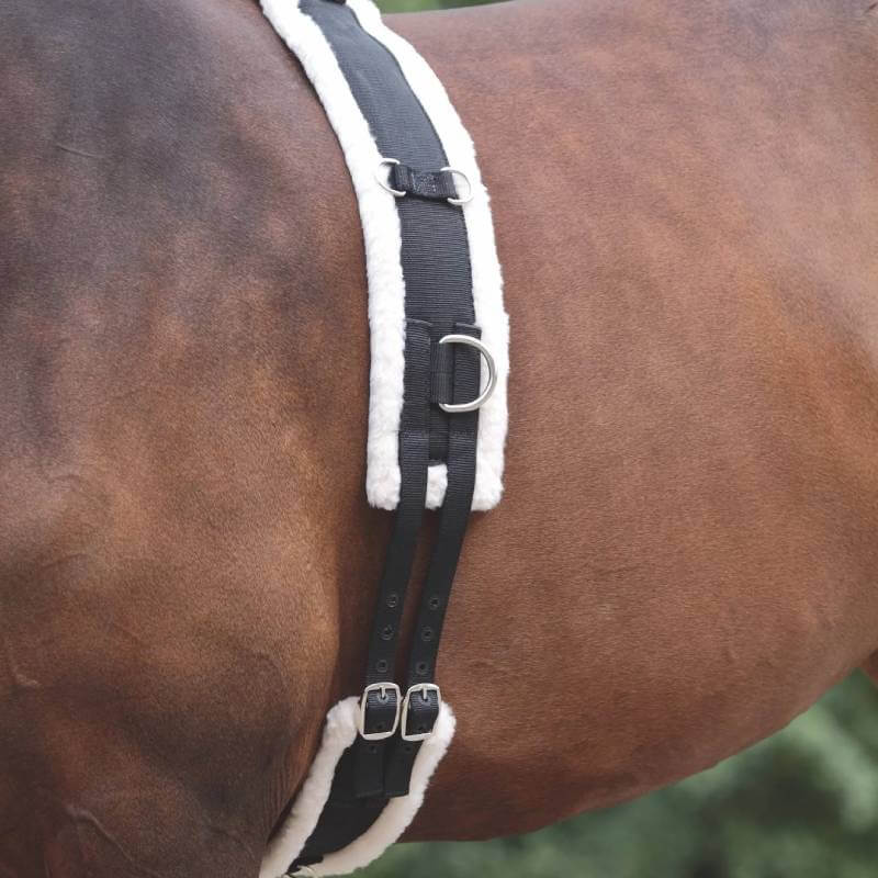 Close-up of a Shires Fleece Roller surcingle fastened on a brown horse.