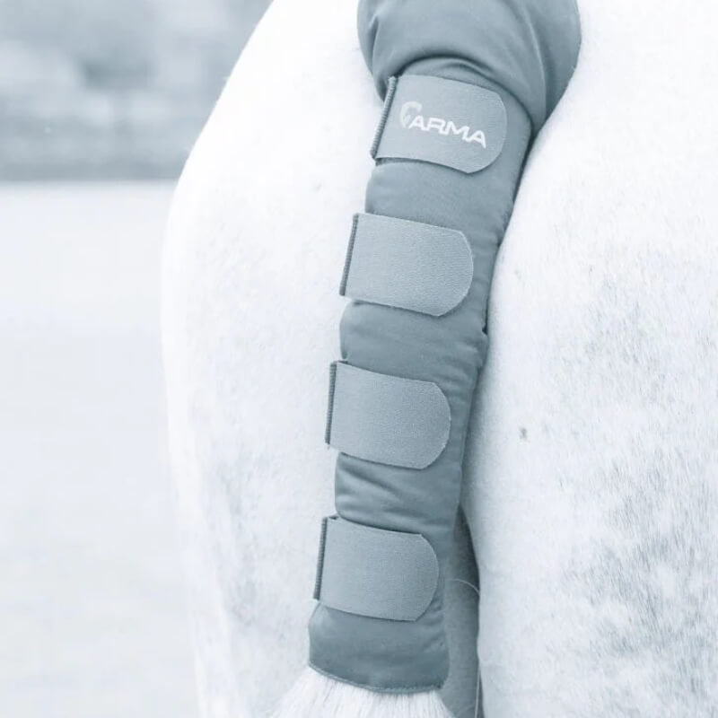 Close-up of a horse’s tail wrapped in a Shires Arma Padded Tail Guard with branded protection.