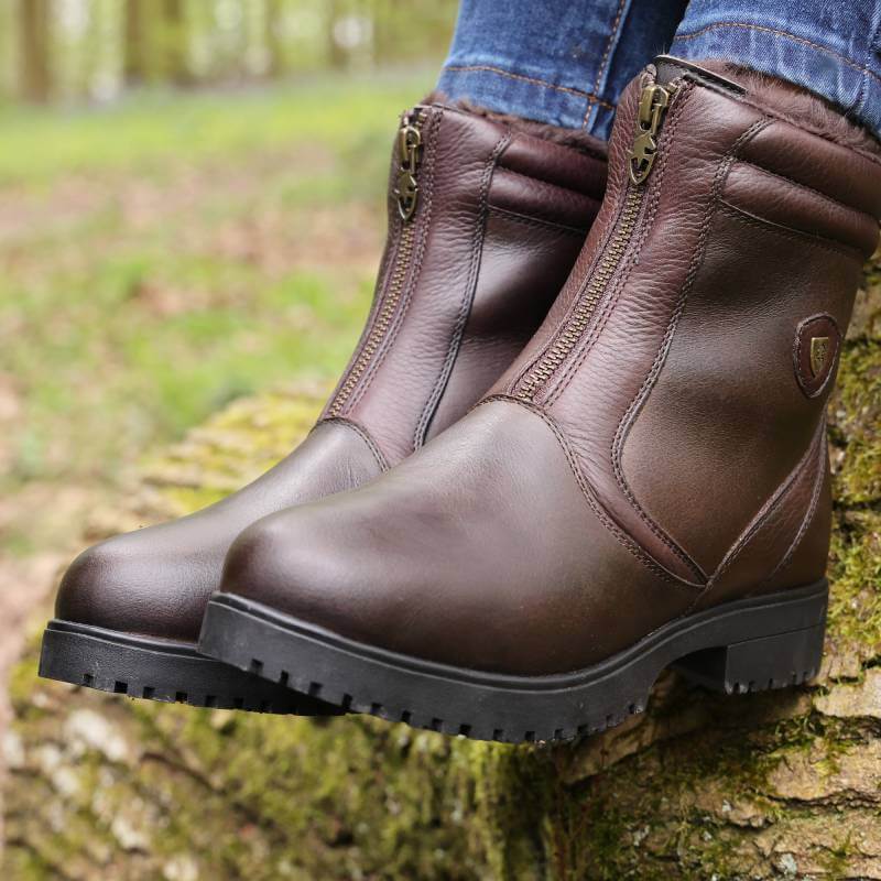 Moretta Atri Zip Country Boots by Moretta, brown waterproof leather, worn on a mossy log.