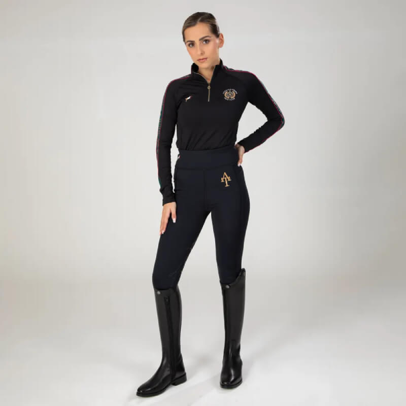 Woman wears Aubrion Team Winter Riding Tights Black by Aubrion against a plain background.