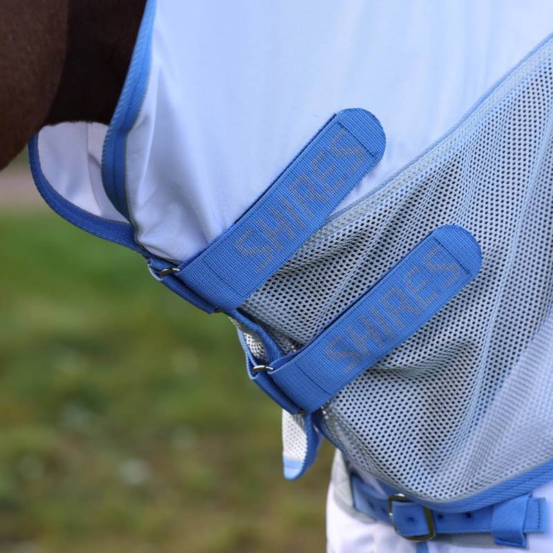 Close-up of the Shires Tempest Original Fly Mesh Combo Rug Sky with blue straps.
