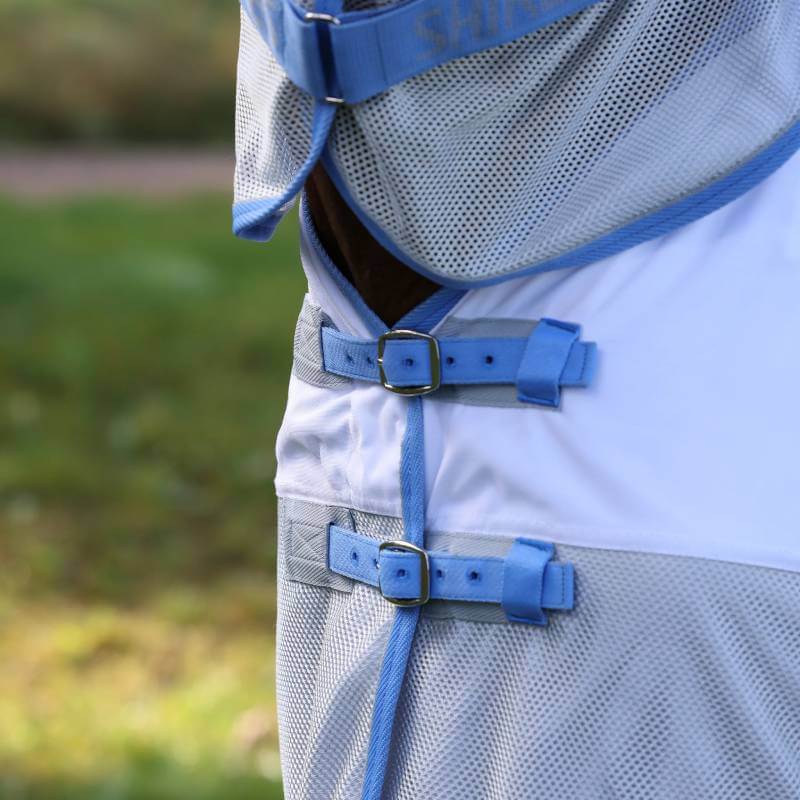 Close-up of blue and gray Shires Tempest Original Fly Mesh Combo Rug Sky buckles for horses.