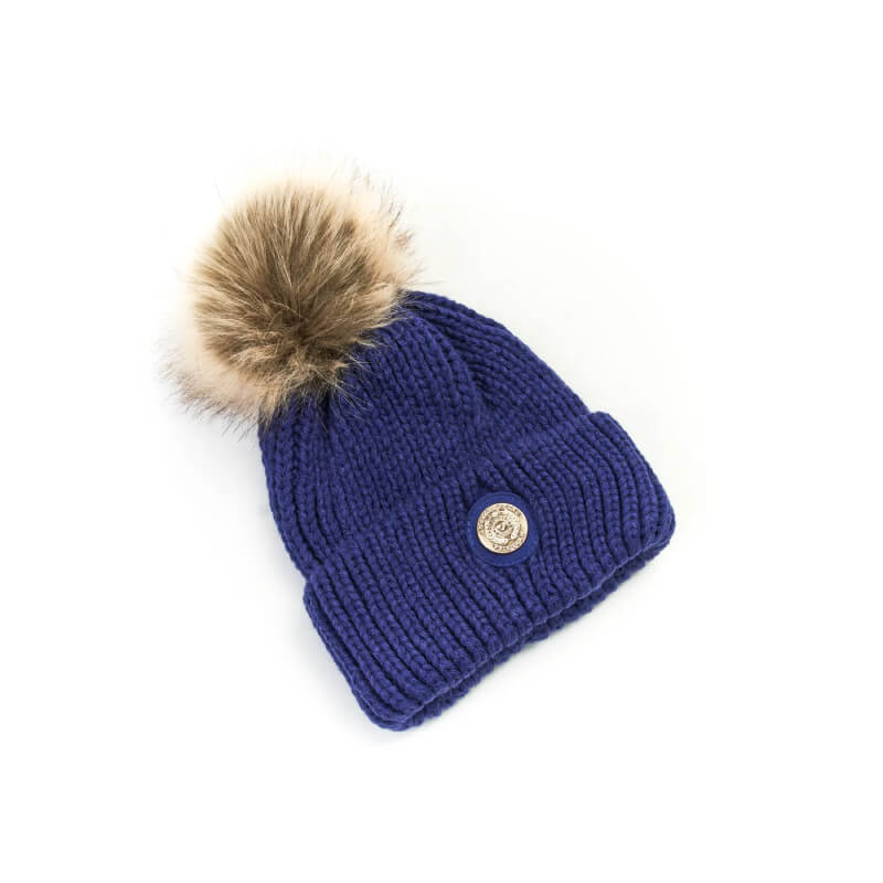 Aubrion Team Winter Hat Navy: Blue knit hat with tan faux fur pom pom and silver button.