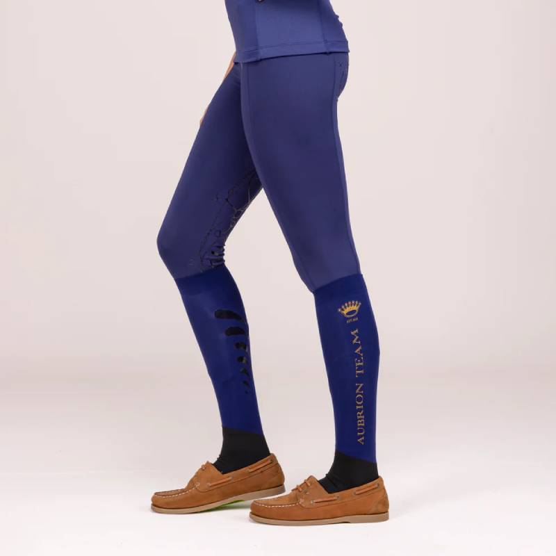 Person in Aubrion Team Riding Tights Midnight, shown from mid-torso to feet.