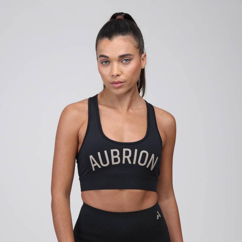 Woman confident in Aubrion React Power Sports Bra Shadow with rapid-dry technology.