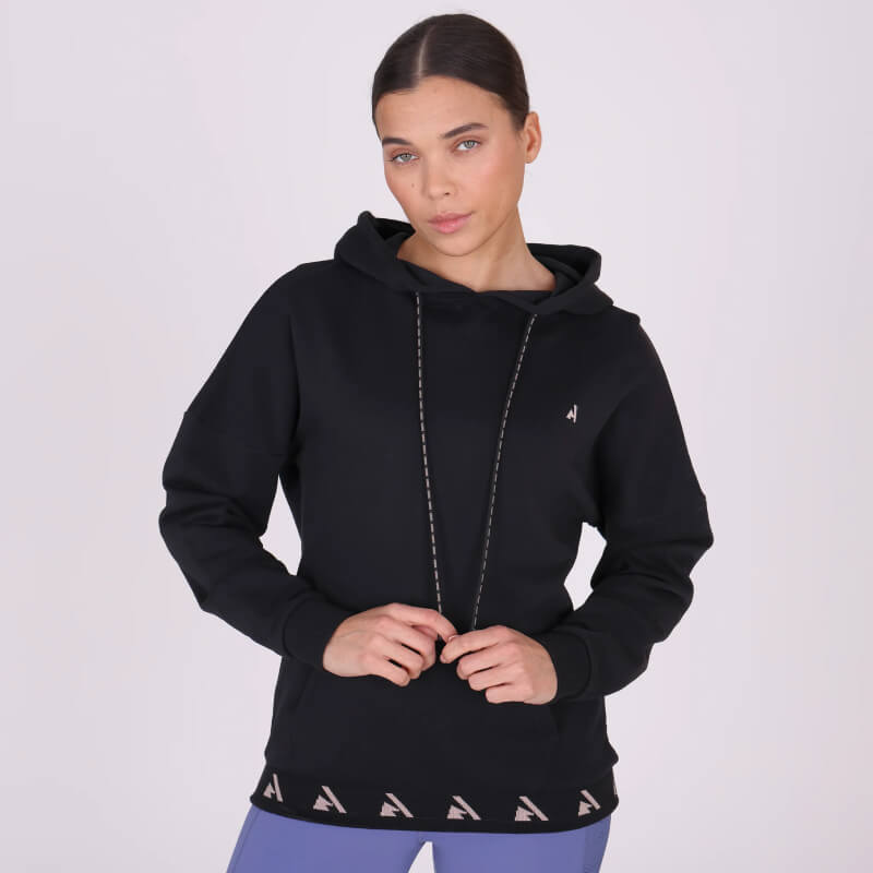Woman in an Aubrion React Hoodie Shadow with logo trim and drawstring detail.