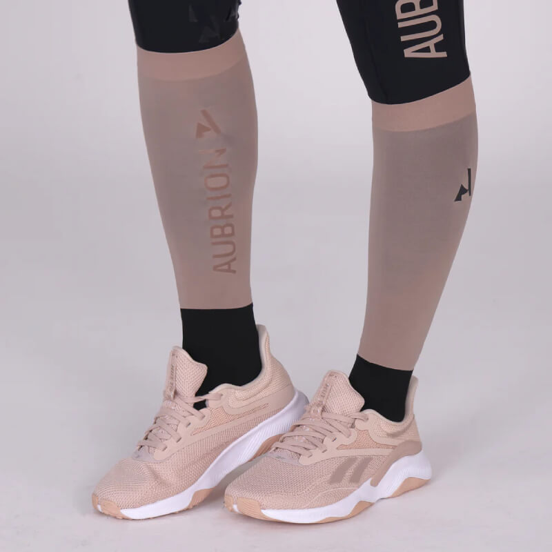 Close-up of legs in Aubrion React Performance Socks Sand and beige athletic shoes.