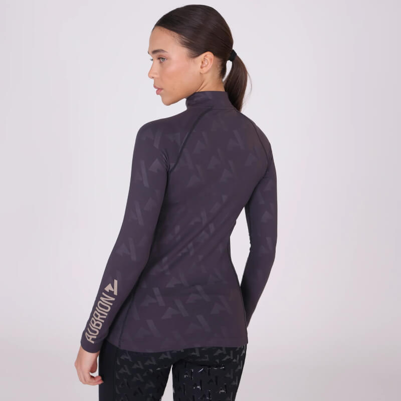 Woman in an Aubrion React Winter Baselayer Shadow, facing away against a plain background.