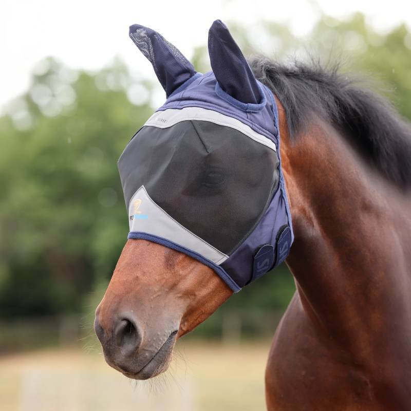 Brown horse outdoors wearing Shires FlyGuard Pro Fine Mesh Fly Mask with Ears Navy.