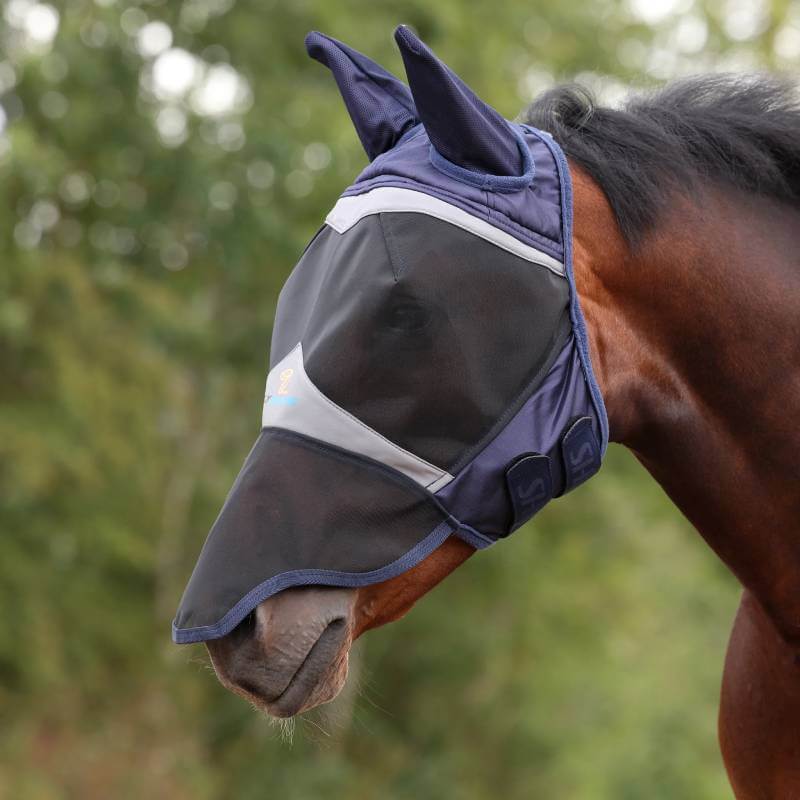 A horse wears the Shires FlyGuard Pro Fine Mesh Fly Mask with Ears &amp; Nose in navy.