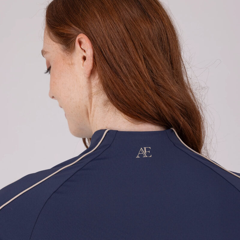 Woman with long brown hair in an Aubrion Equestrian Short Sleeve Baselayer Midnight.