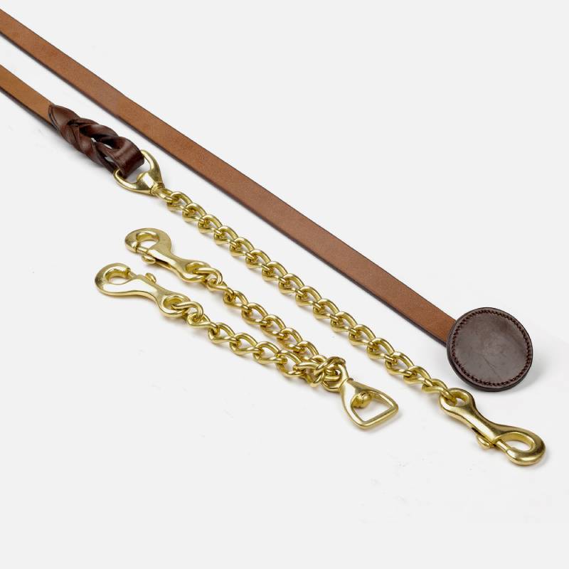 The John Whitaker Whitaker Leather Show Lead Oak Brown with brass chain on white background.