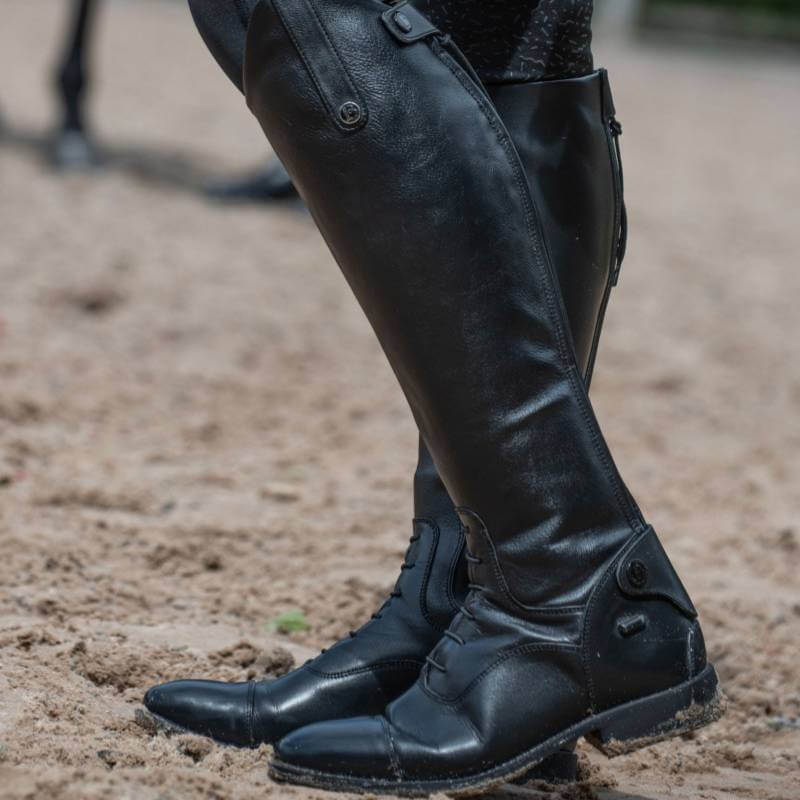 Person wearing Brogini Como V2 Riding Boots standing on sandy ground.