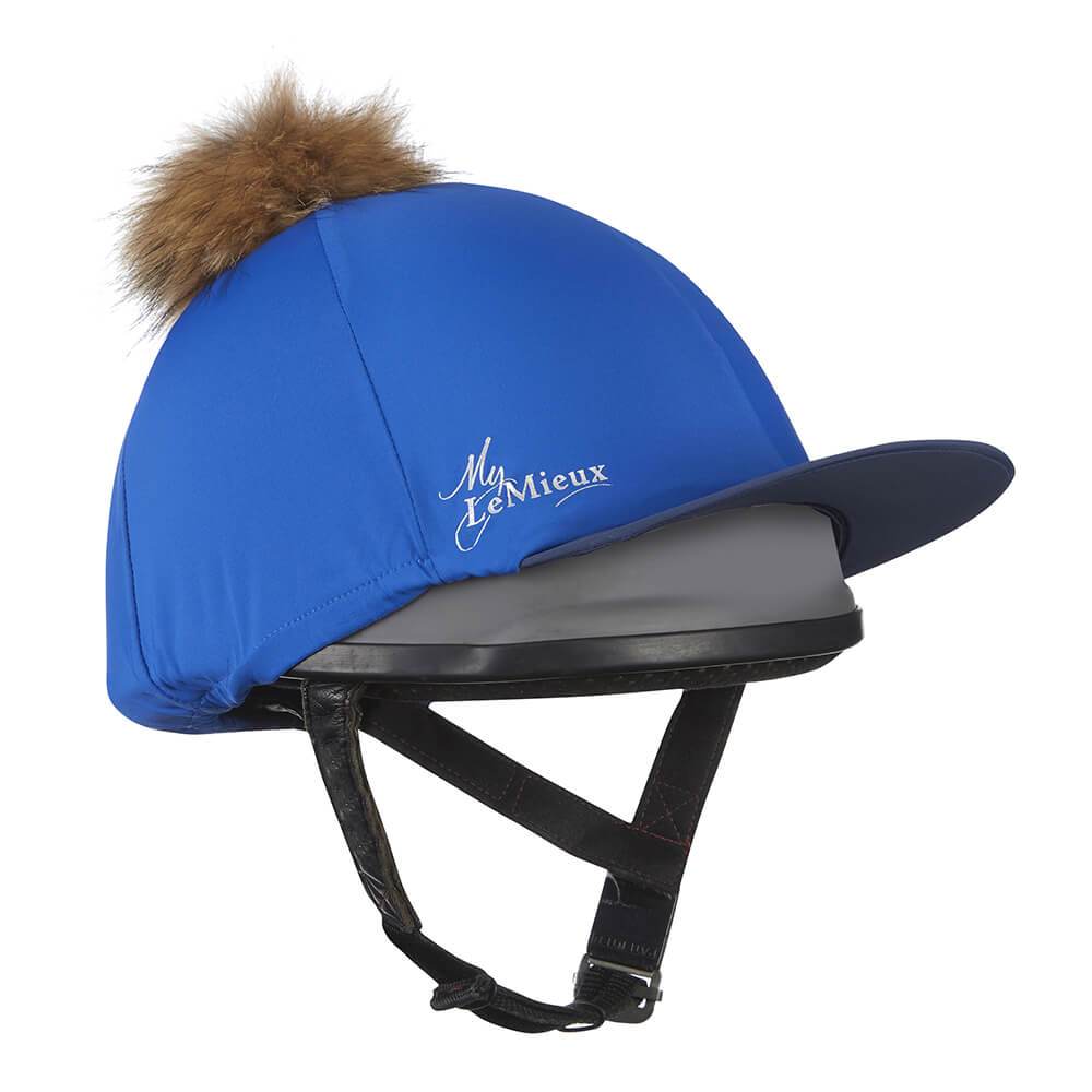 LeMieux Pom Pom Hat Silk in blue with brown faux fur pom pom, shown on a black helmet.