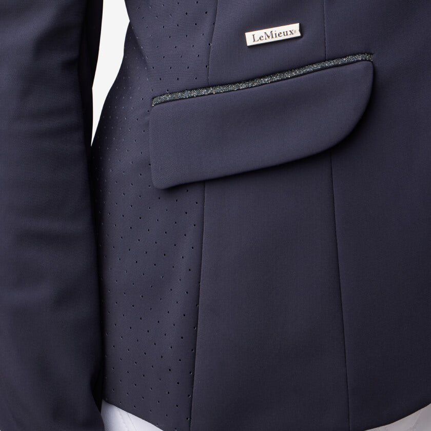 Close-up of the LeMieux Dynamique Show Jacket Ladies Navy label above the pocket.