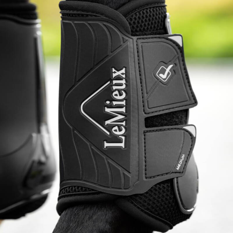 Close-up of LeMieux Motion Flex Dressage Boot Black with secure straps for horse leg protection.