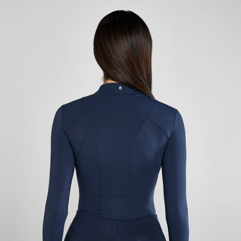 Model with long dark hair wears Aztec Diamond Core Baselayer Navy, back view shown.