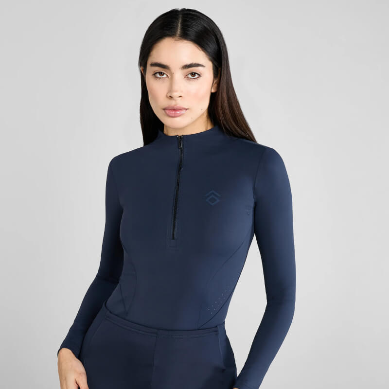 Woman wearing the Aztec Diamond Core Baselayer Navy with UV protection against a plain background.