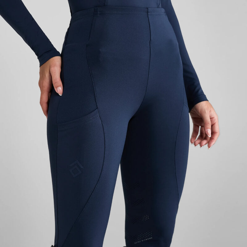 Person wearing Aztec Diamond Core Leggings Knee Grip Navy, hand on thigh, plain background.