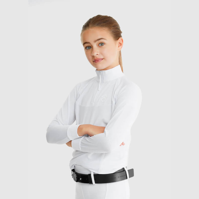 Confident girl in Aztec Diamond YR Mesh Shirt White stands arms crossed on plain background.