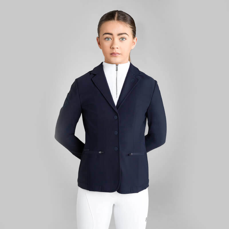 Young rider in Aztec Diamond YR Competition Jacket Navy stands against a light gray background.