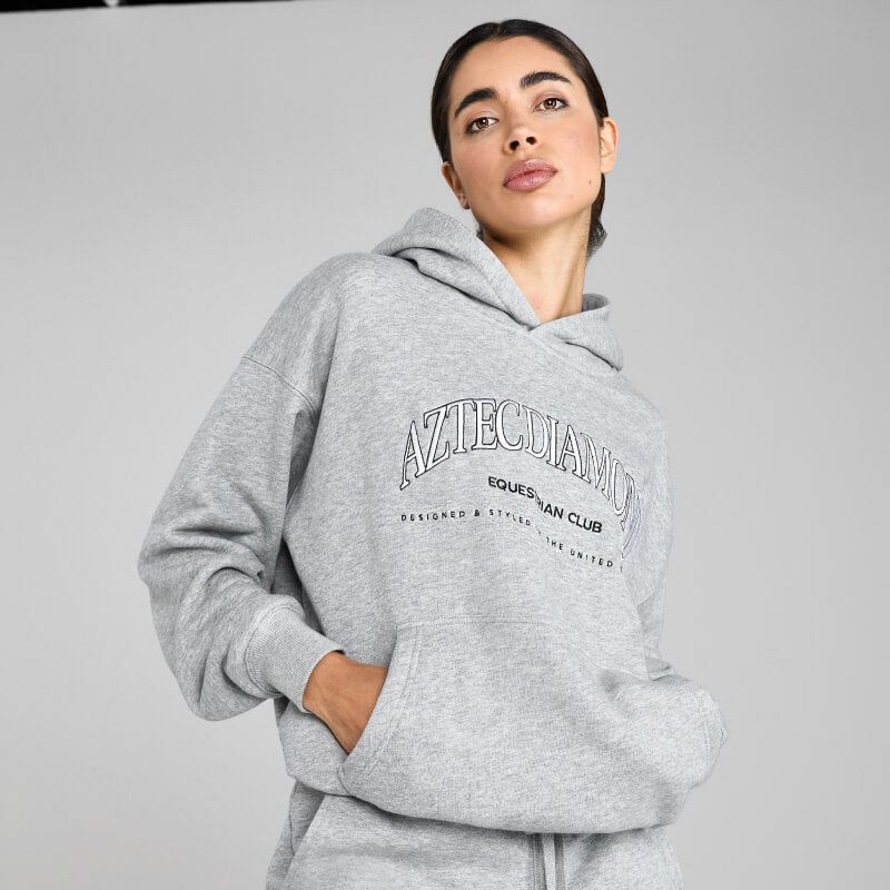 Woman in an Aztec Diamond EQ Club Pull on Hoodie Grey Marl by Aztec Diamond.