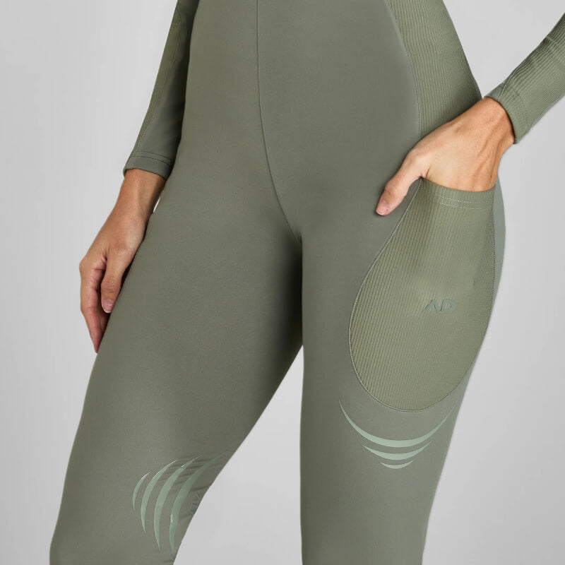 Wearing Aztec Diamond Define Leggings Knee Grip Sage with a hand in one thigh pocket.