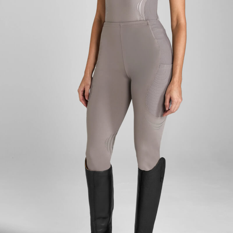 Model in Aztec Diamond Define Leggings Knee Grip Truffle and tall black riding boots, shoulders down.