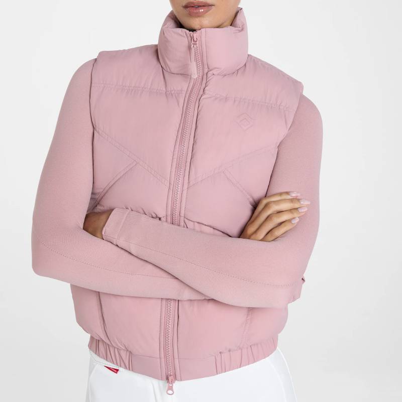 Person in Aztec Diamond Pink Core Mid-layer Gilet, arms crossed, white pants, on white background.