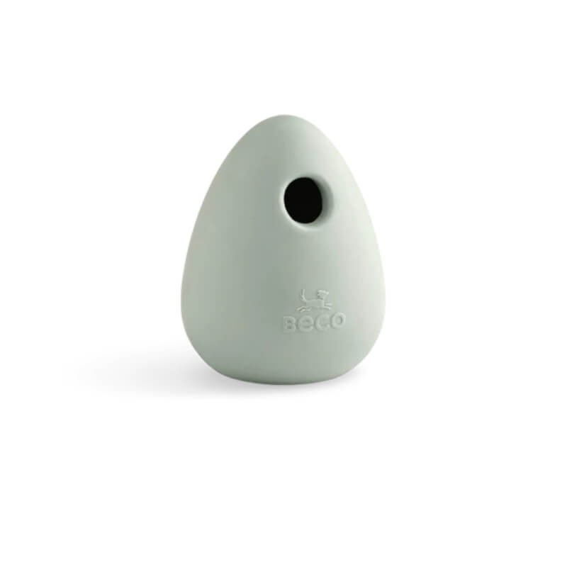 Green, egg-shaped Beco Boredom Buster toy made from natural rubber with a small hole.