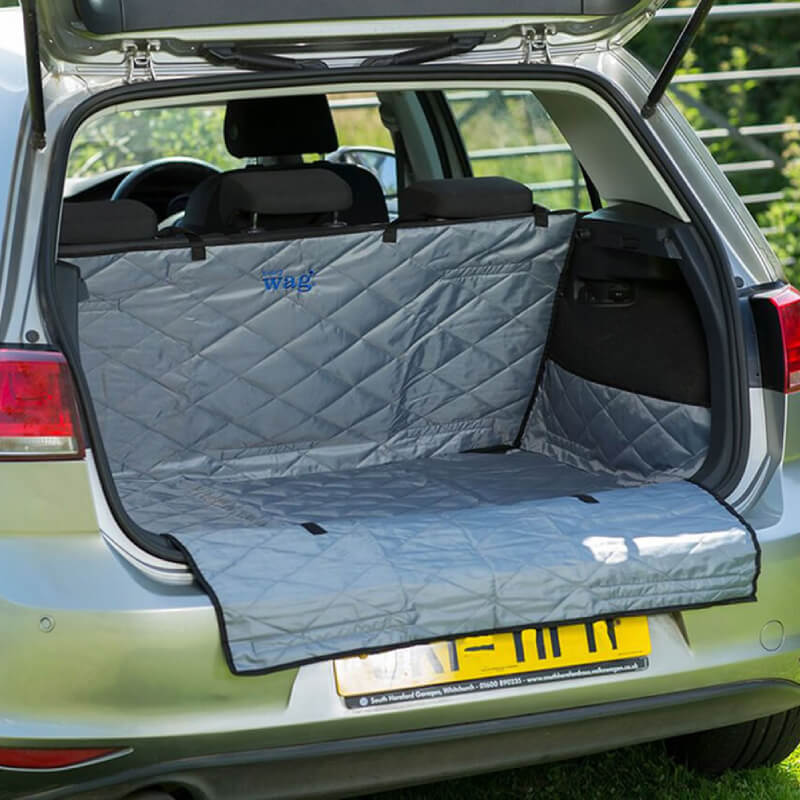 A silver car with a Henry Wag Pet Car Boot N Bumper Protector in its open trunk.