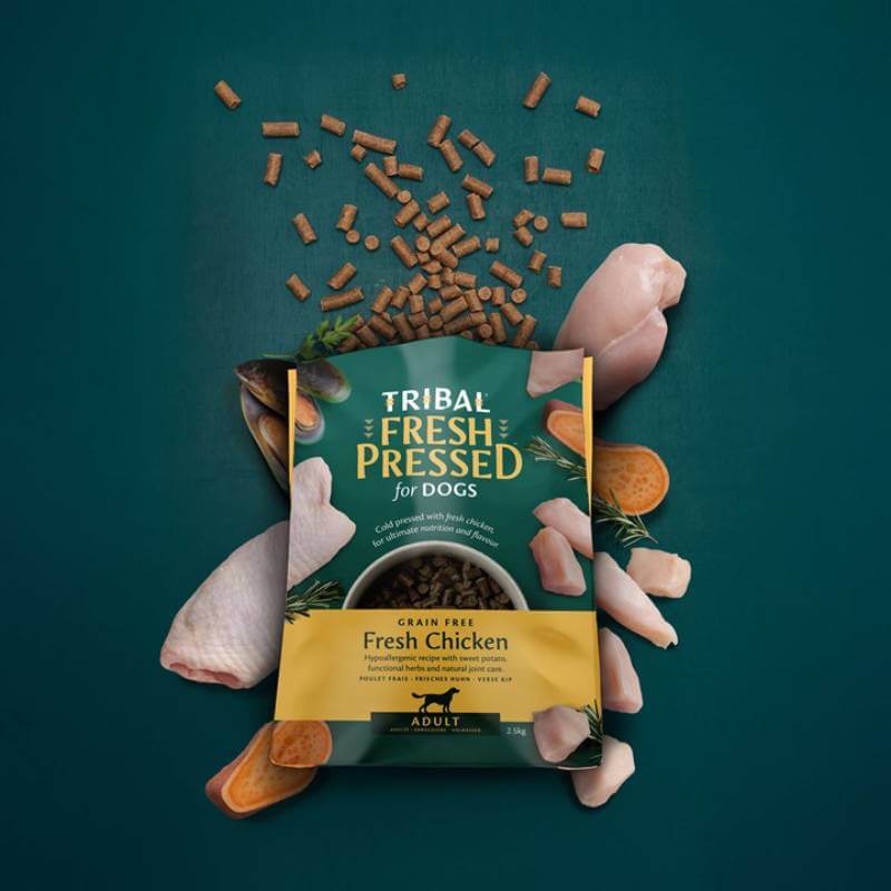 Tribal Fresh Pressed Dry Dog Food Adult Chicken surrounded by kibble and sweet potato.
