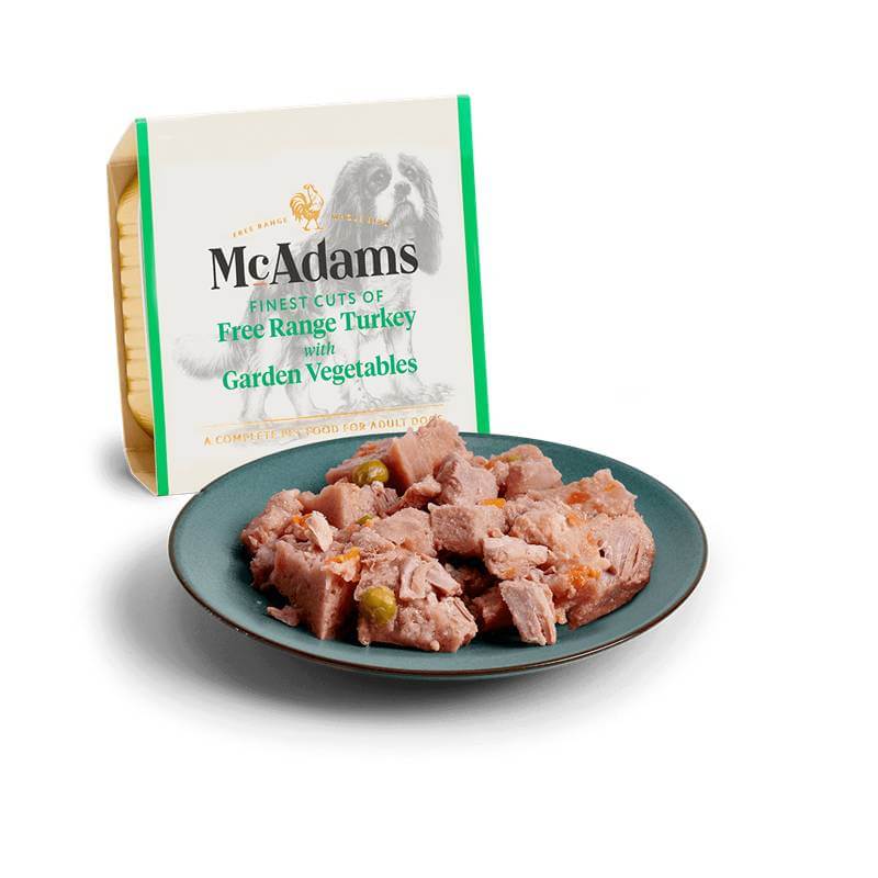 A plate of McAdams Wet Dog Food Free Range Turkey with Garden Veg 150g and box behind.