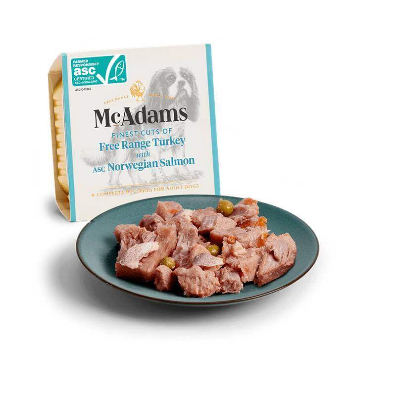 McAdams Wet Dog Food Free Range Turkey &amp; MSC Salmon 150g chunks on a plate, box in back.