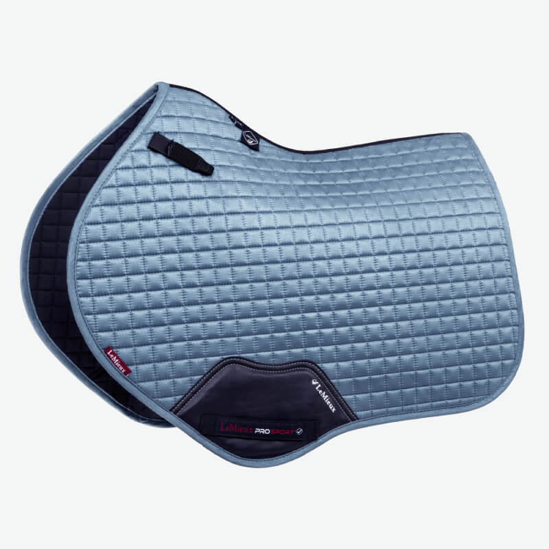 LeMieux Suede Close Contact Square Ice Blue saddle pad with black trim and a red label.
