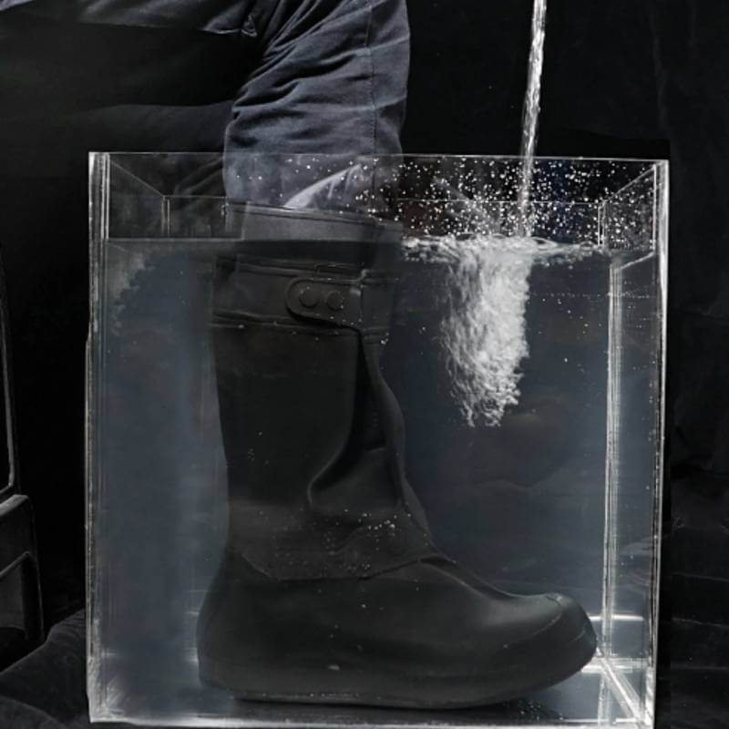 Reinwear Reinboots Black in a tank, water pours over its waterproof overshoes.