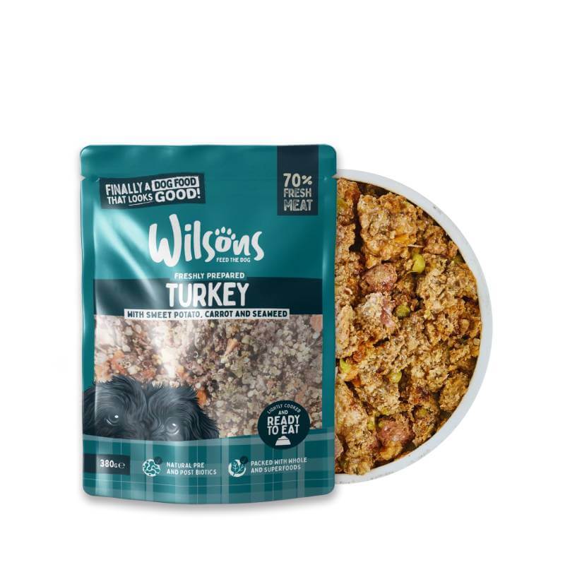 Wilsons Premium Fresh Dog Food Turkey 380g beside a bowl of fresh, ready-to-eat dog food.
