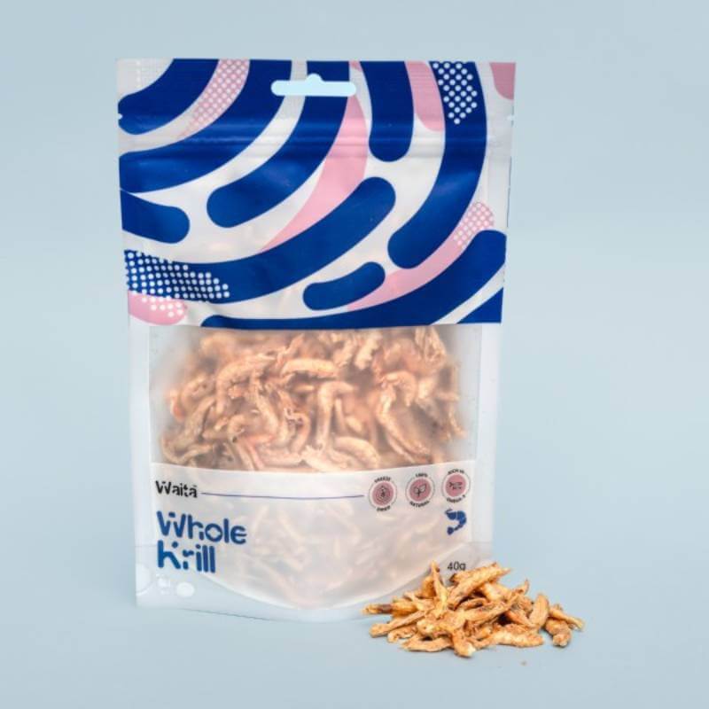 A Waita Freeze Dried Whole Krill Dog &amp; Cat 40g bag with krill spilled on a light blue background.