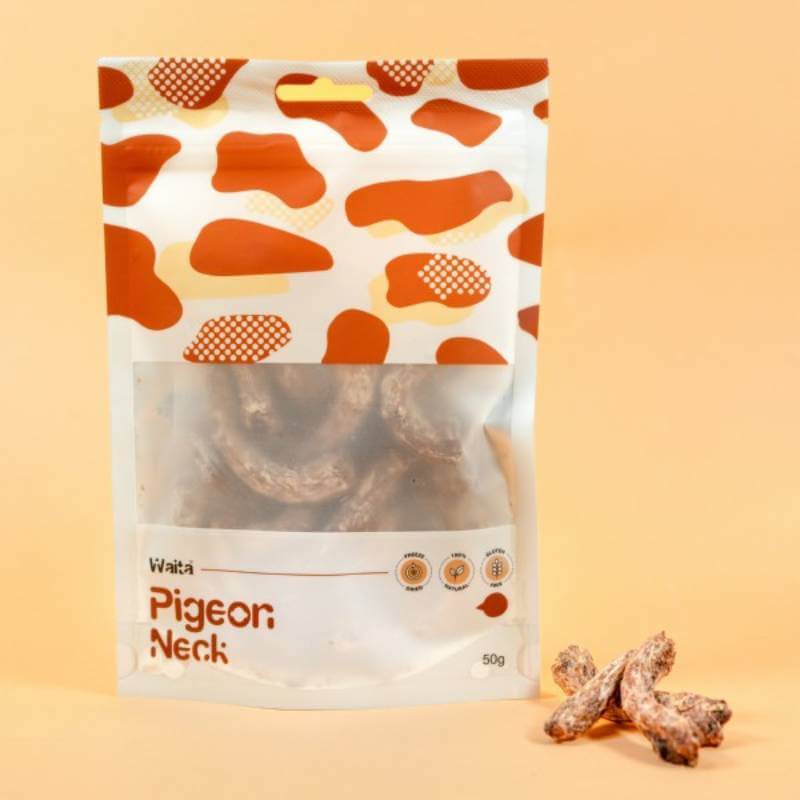 Waita Freeze Dried Pigeon Neck Dog &amp; Cat 50g bag with treats and a few pieces shown beside it.