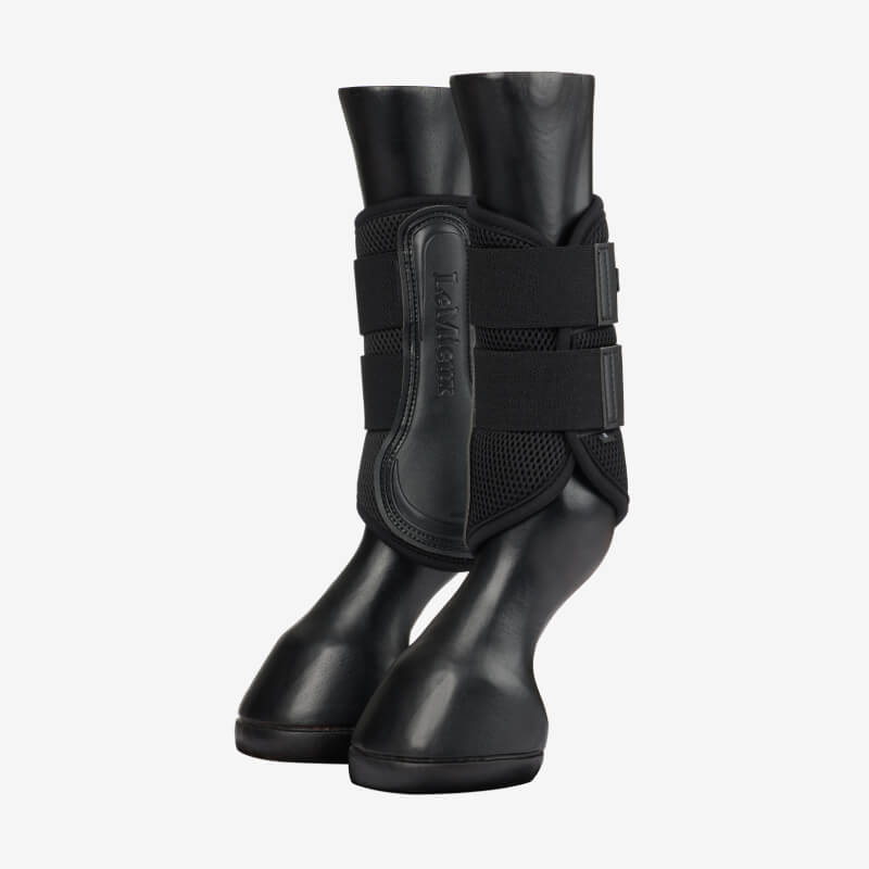 LeMieux Mesh Brushing Boot Black by LeMieux on mannequin legs, white background.