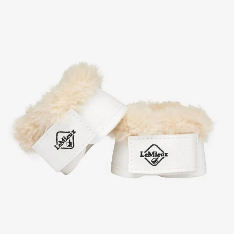 Two LeMieux Toy Pony Dressage Over Reach Boots in white on a plain background.