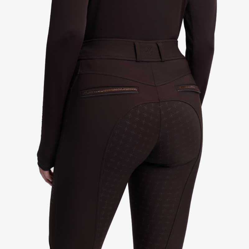 Person in LeMieux Brilliance Full Seat Breeches Espresso with back pockets and patterned seat patches.