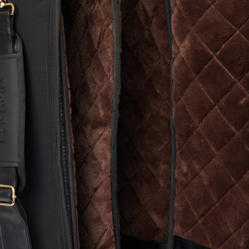 Close-up of the LeMieux Luxe Boot Bag Black with quilted faux fur lining and a leather strap.