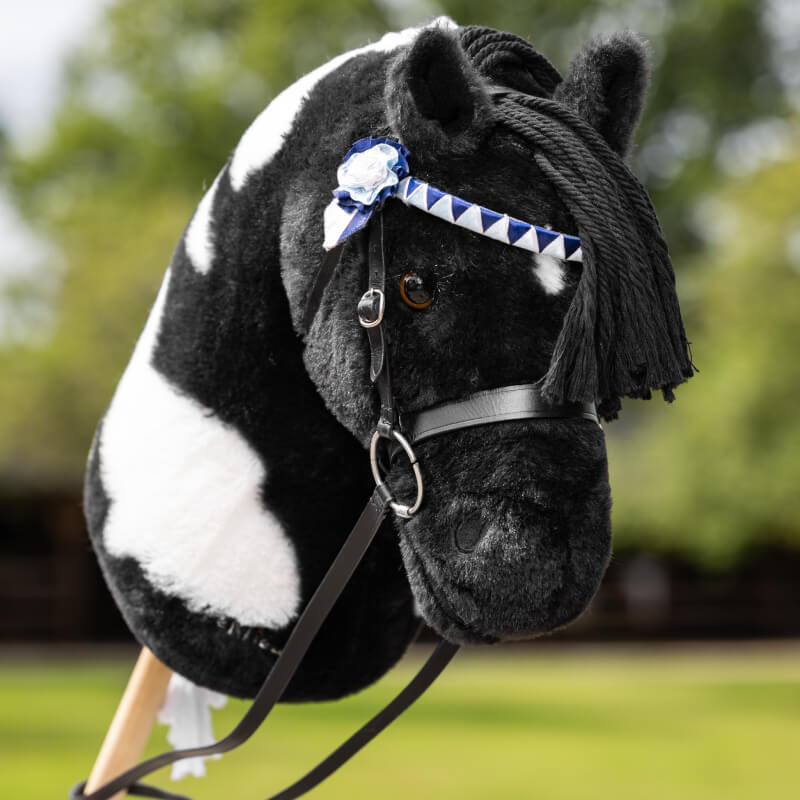 LeMieux Hobby Horse Showing Bridle Black by LeMieux, with blue and white ribbon on its head.