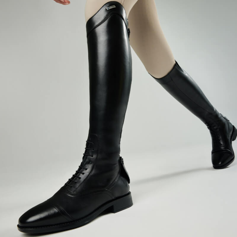 Close-up of LeMieux Field Riding Boot Black Regular/Slim with ergonomic footbed and beige tights.