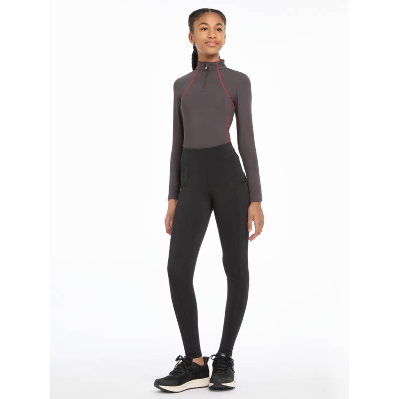 Woman smiles in LeMieux Young Rider Orla Pull Ons Black against a plain white background.