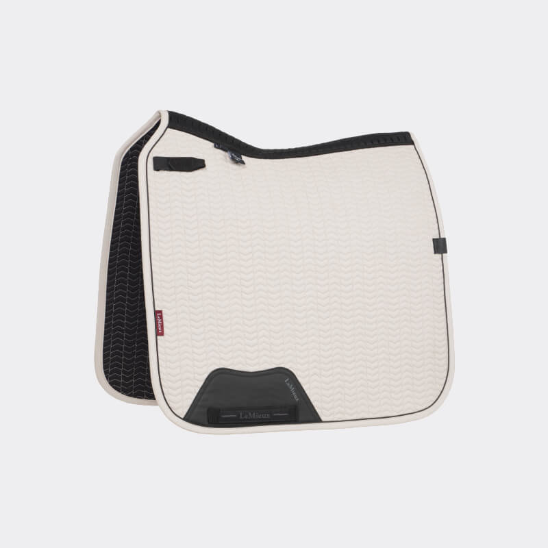 Cream Lemieux Essence Dressage Square Stone pad by LeMieux, black trim and small black patch.